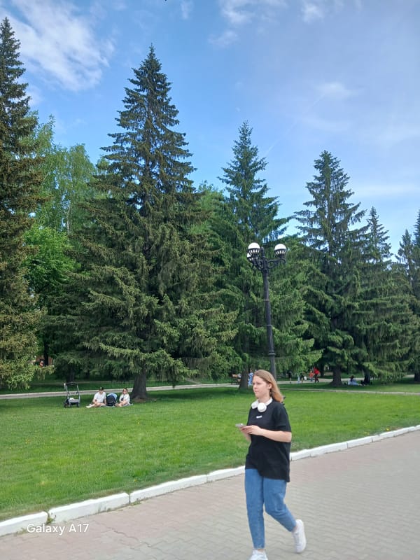 Casual park scene captured in Yekaterinburg with pedestrians, cyclists