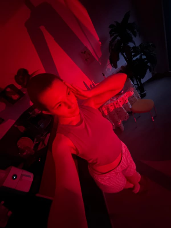 Person recorded in red-lit room, Vozdovac Serbia