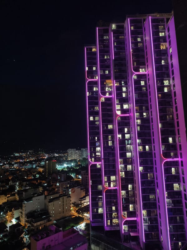 Colorful nighttime city skyline observed from multiple angles