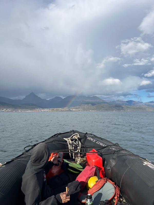 Rainbow appears over Ushuaia during boat tour excursion