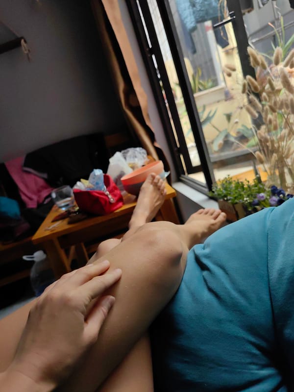 Person in blue shirt sits indoors in Hà Nội