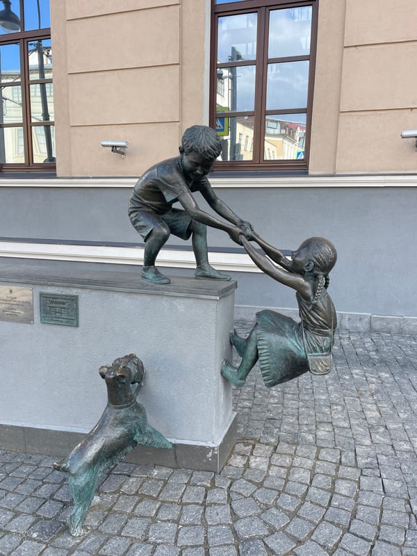 Ordinary day captured on Kazan streets with pedestrians and sculptures