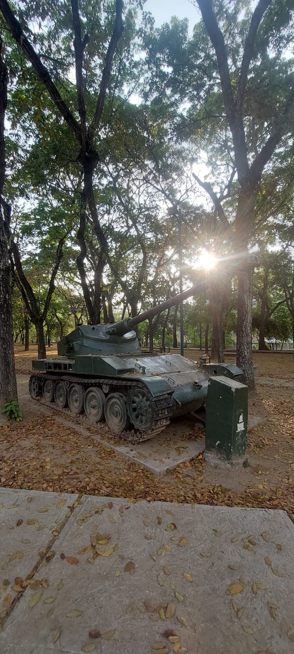 Evening visitors document military displays at Caracas park