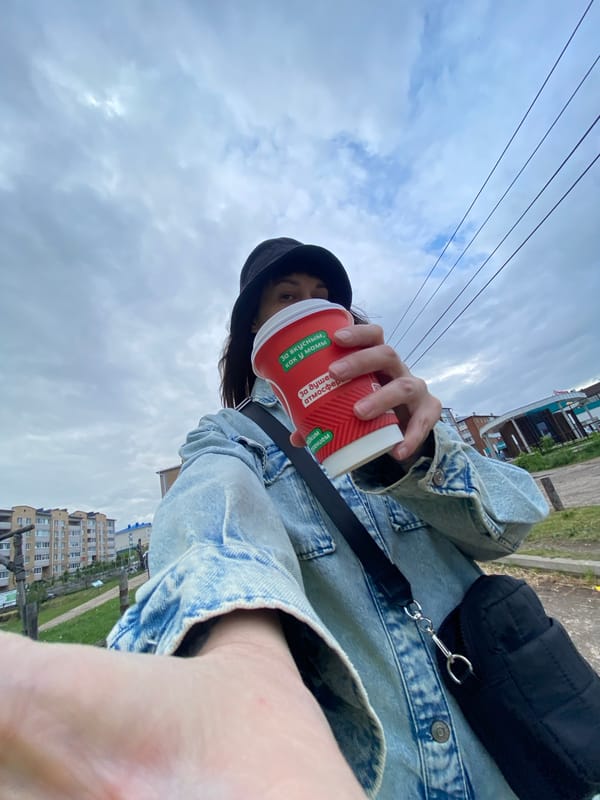 Person with red cup photographed in Votkinsk urban setting