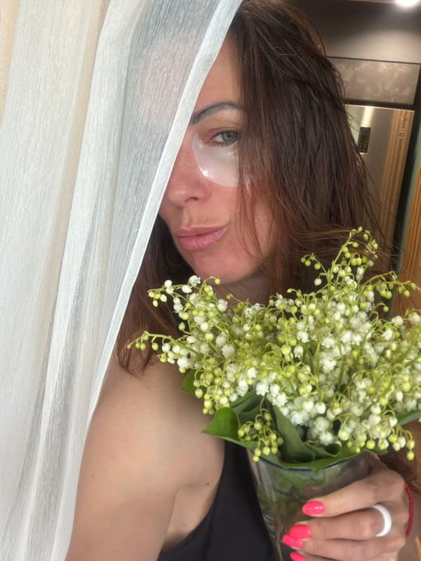 Woman with lilies captured in intimate indoor moments, Birobidzhan