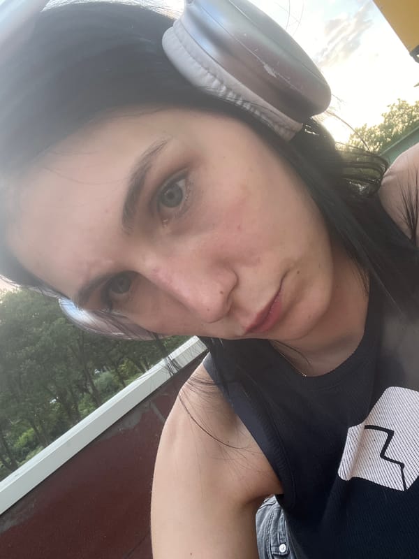 Chilling on a rooftop court with headphones and a beer