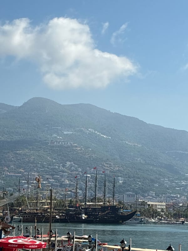 Alanya landmarks: hillside signage and a suited statue