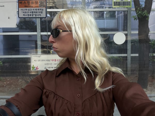 Blonde-haired individual and digital graphic spotted in Seoul