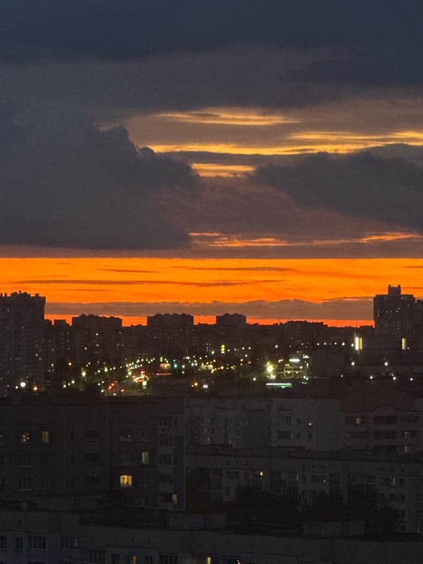 Balcony evening in Minsk, fiery sunset over Soviet skyline