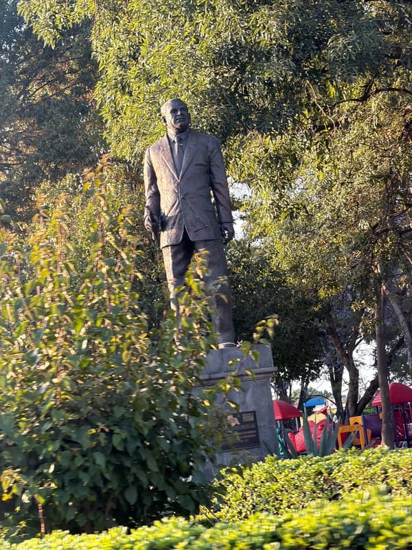 Bronze statue observed in green surroundings in Cholula, Mexico