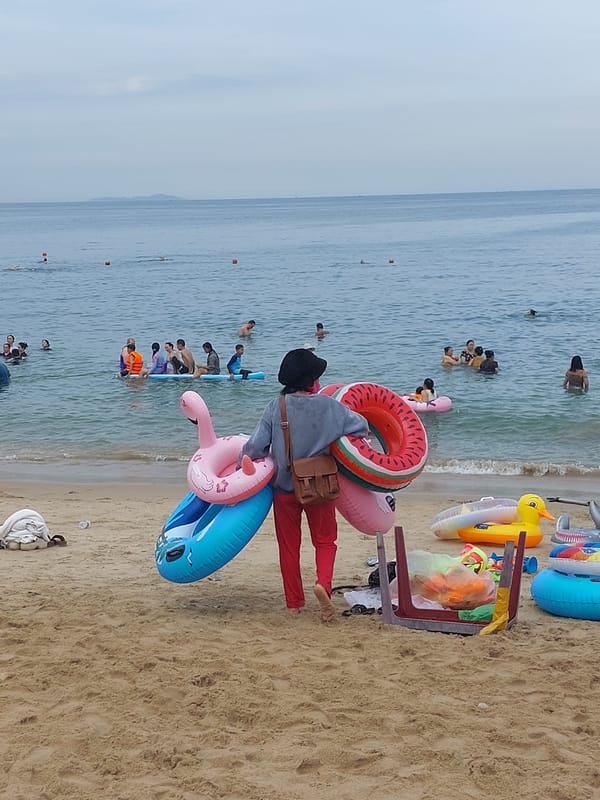 Nha Trang beach morning: rentals, paddleboards, and busy streets