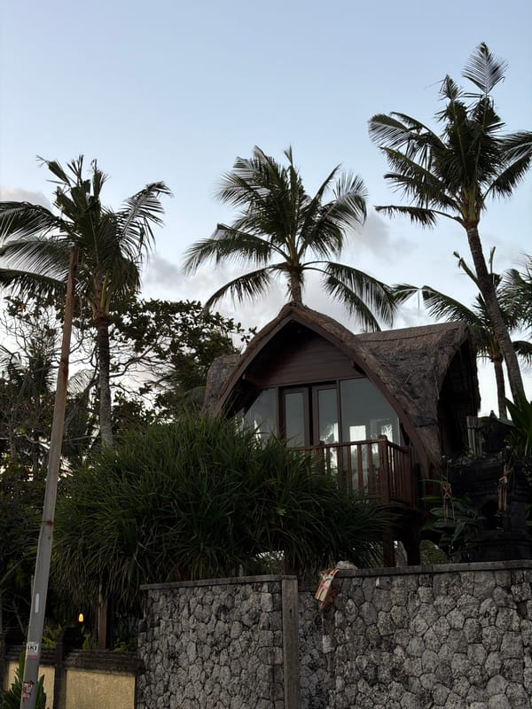 Thatched hut among palms in Mengwi, Bali