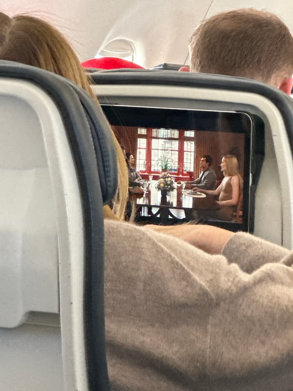 Passenger watches video on device during flight over Ibiza