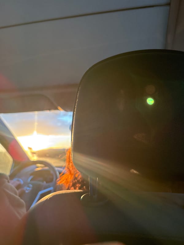 Woman drives through bright sunlight in Saraia, Bulgaria