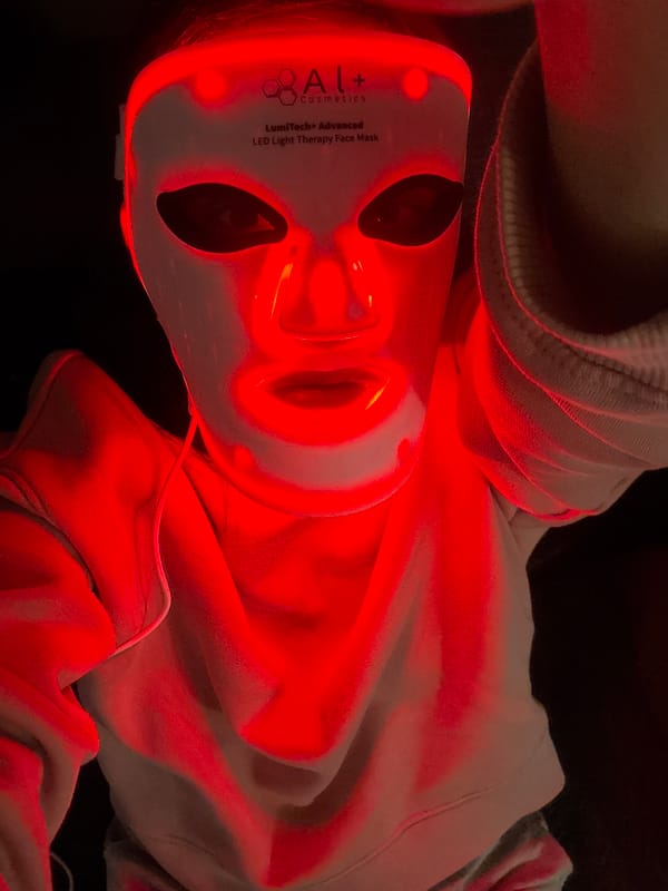 Person spotted wearing glowing red LED therapy face mask