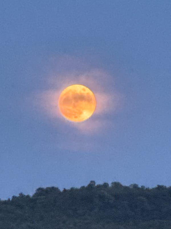 Full moon observed through clouds in Strazhitsa, Bulgaria