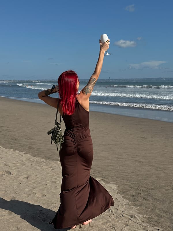 Woman poses for photos on stone pathway in North Kuta