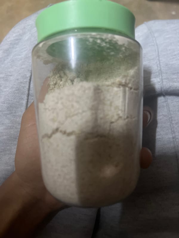 Person holds powder-filled jar in Dar es Salaam