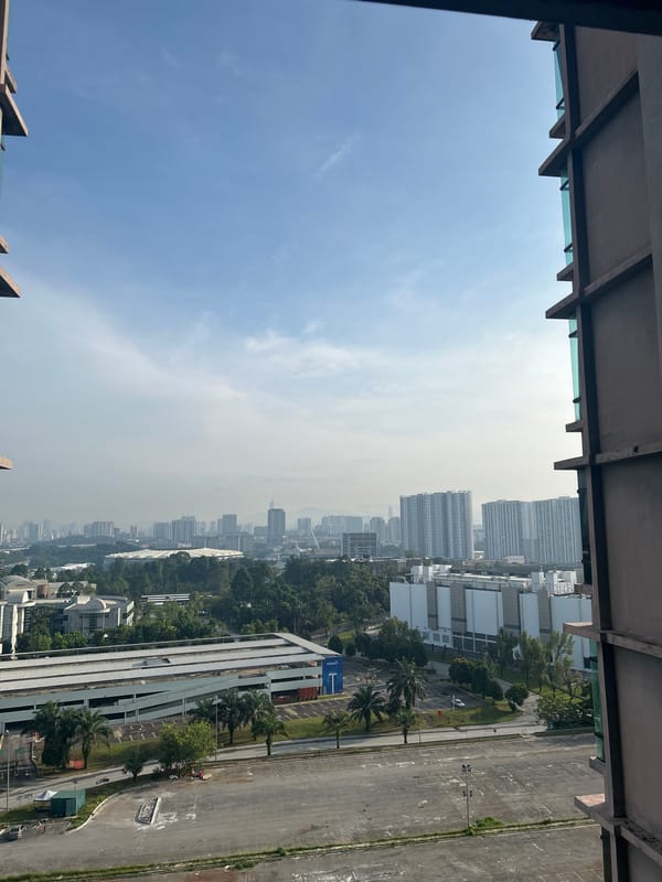 Witness documents nighttime Kuala Lumpur cityscape from high-rise vantage point
