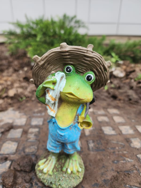 Spring garden display features ceramic figurines among flowers in Kazan