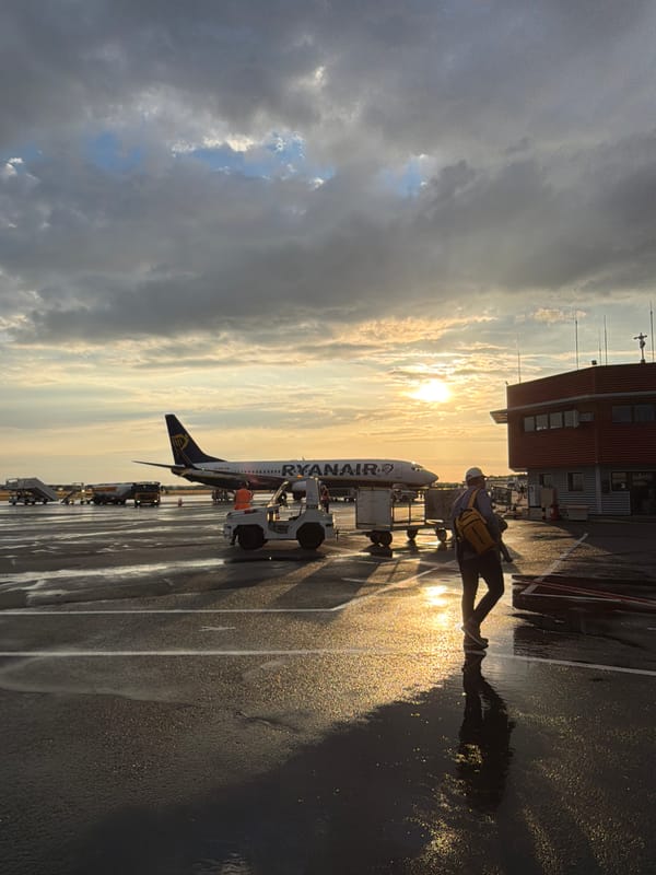 Ryanair jet on wet tarmac at Beauvais-Tillé during sunset