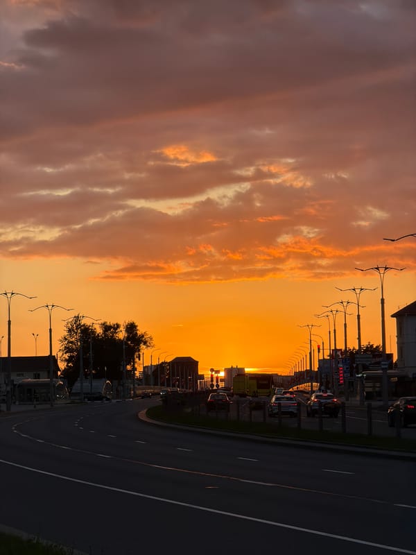 Orange sunset sky over Minsk city streets