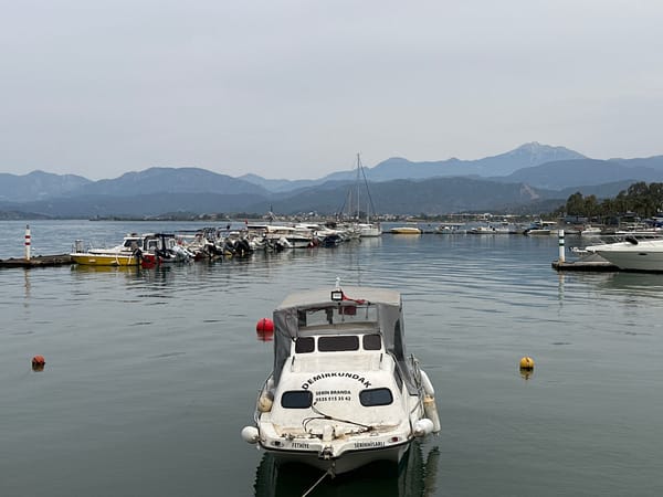 Woman with stroller visits Fethiye harbor on quiet morning