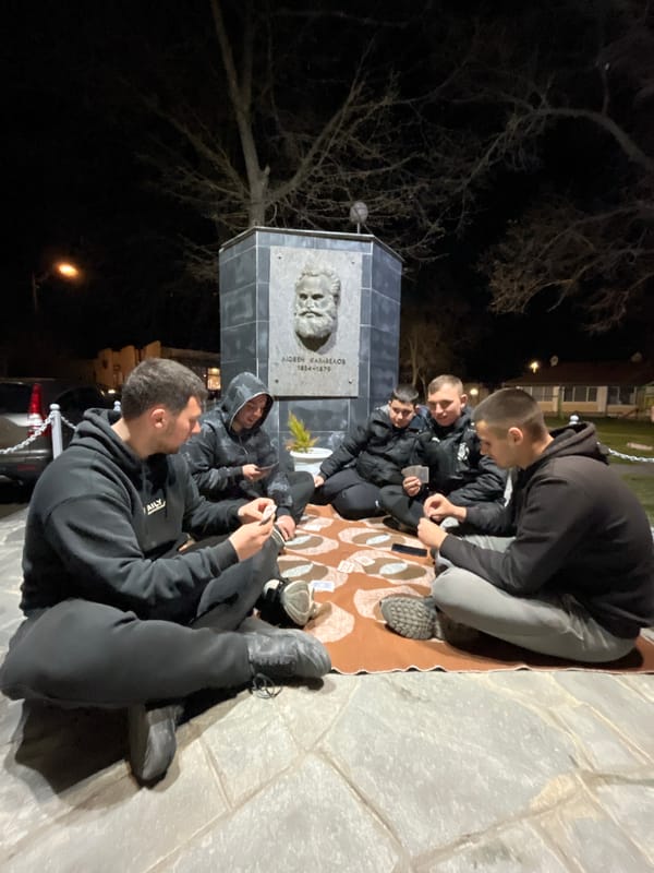 Evening card game gathering near monument in Karavelovo, Bulgaria