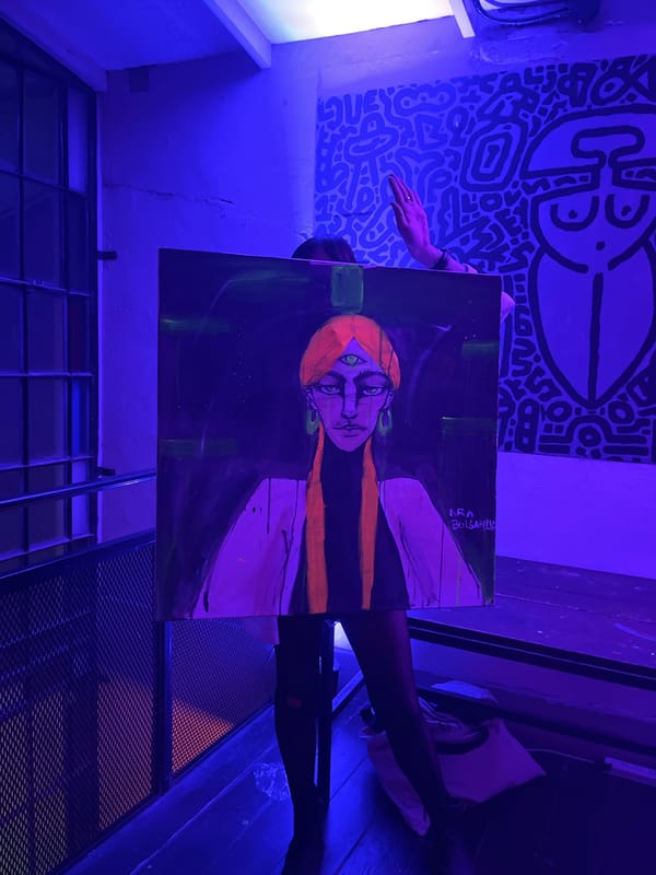 Person holds painting in Buenos Aires art space