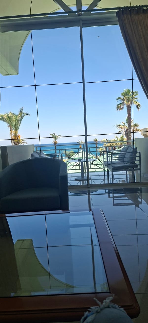 Relaxed afternoon in a Rhodes hotel lobby overlooking the sea