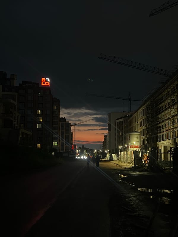 Sofia evening captures construction cranes and bilingual fortune message