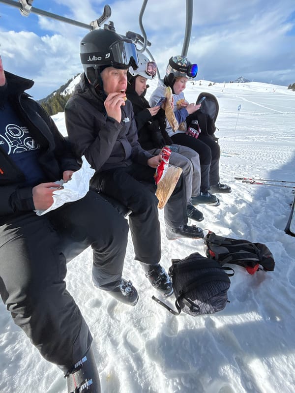 Five skiers ride chairlift in Villard-sur-Doron mountains