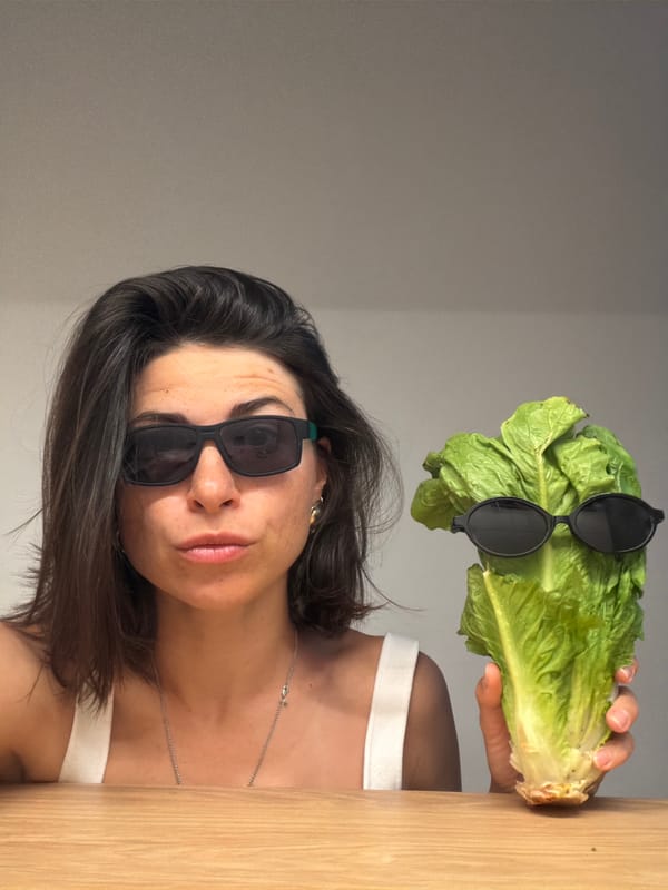Woman poses with sunglasses-wearing lettuce in playful Montenegro photo session