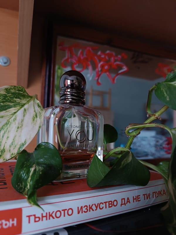 Cologne bottle photographed atop Bulgarian self-help book in Veliko Tarnovo