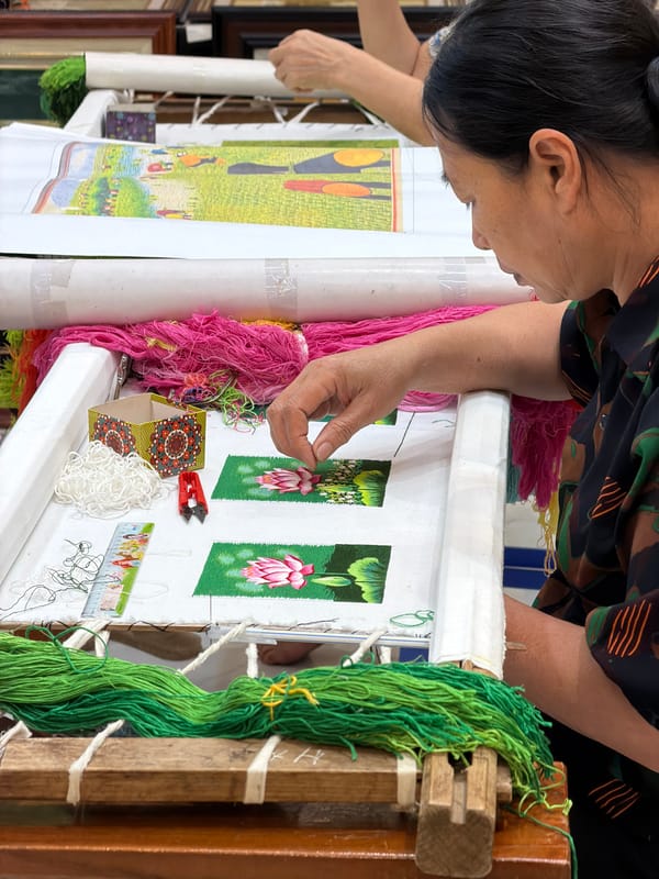 Vietnamese artisan practices traditional embroidery in Hải Phòng workshop