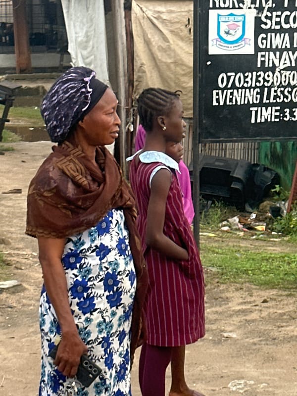 Morning street life along a Badagry sidewalk