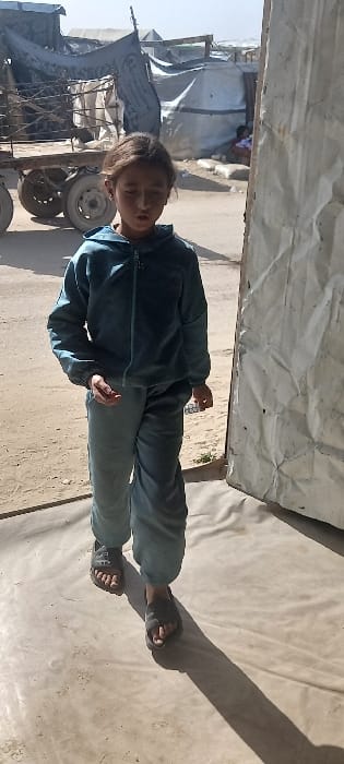 Residents walk dirt paths in Khan Yunis settlement area