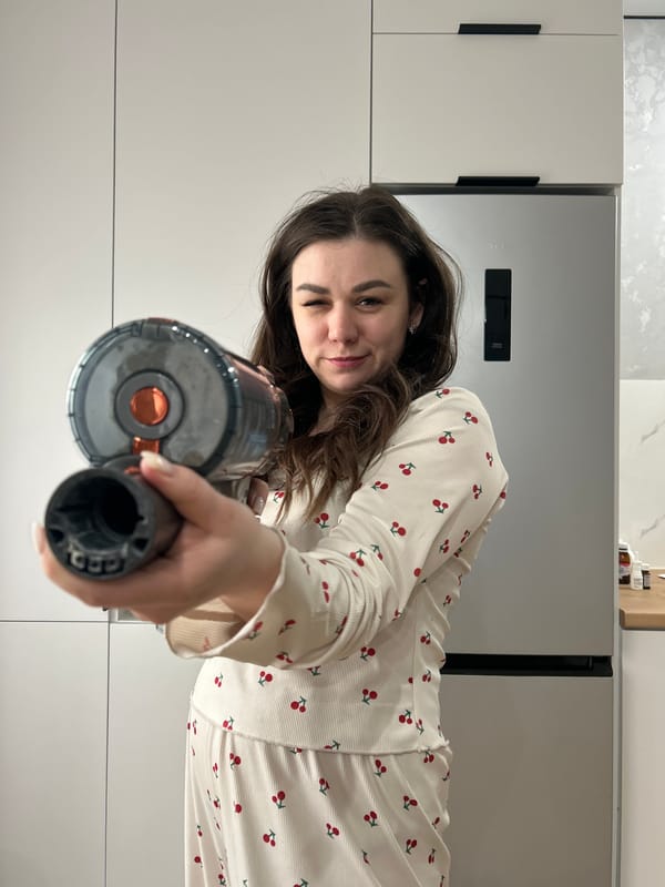 Woman poses with vacuum cleaner in Chaikovsky home