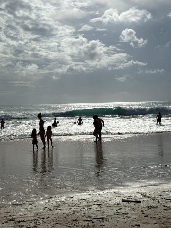 Woman and child enjoy morning beach time in Kuta