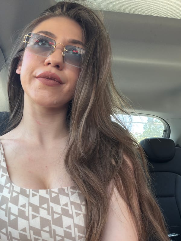 Woman takes car selfies in Sofia wearing sunglasses