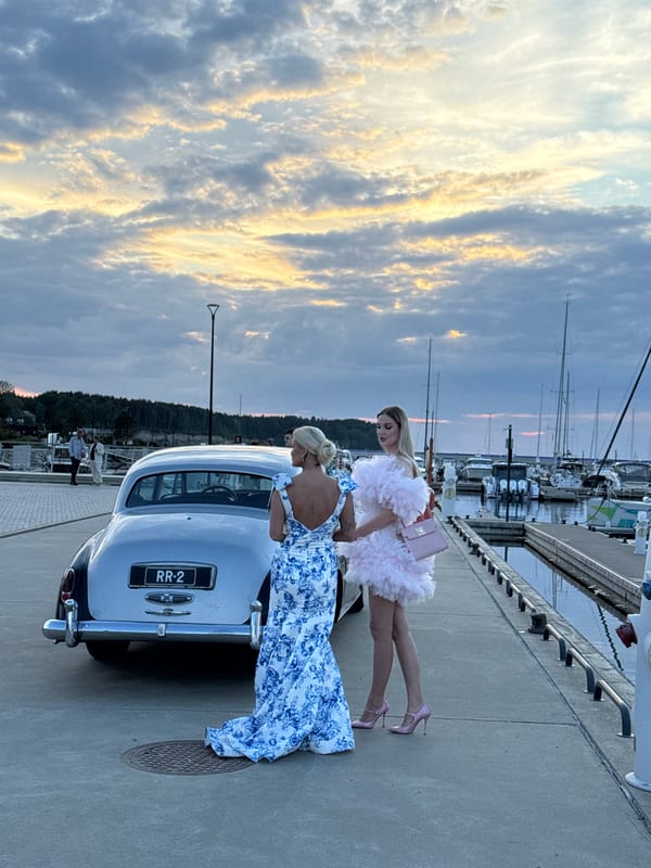 Luxury car gathering at Tallinn marina during golden hour