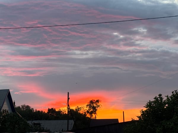 Sunset over rural Rodino, plus a weathered greenhouse nearby