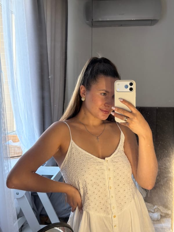 Woman takes mirror selfies in white dress near Moscow