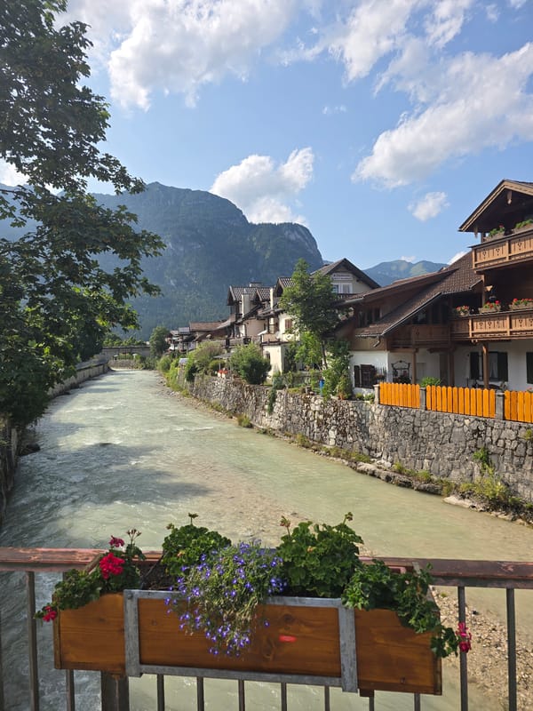 Loisach River and flower-lined streets of Garmisch-Partenkirchen in summer