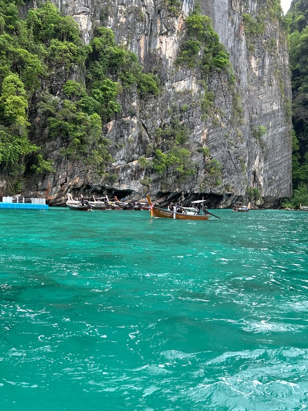 Morning boat traffic navigates limestone cliffs in Ao Nang