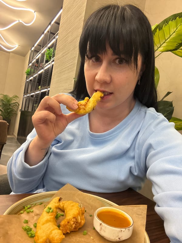 Woman enjoys fried food at table in Izhevsk