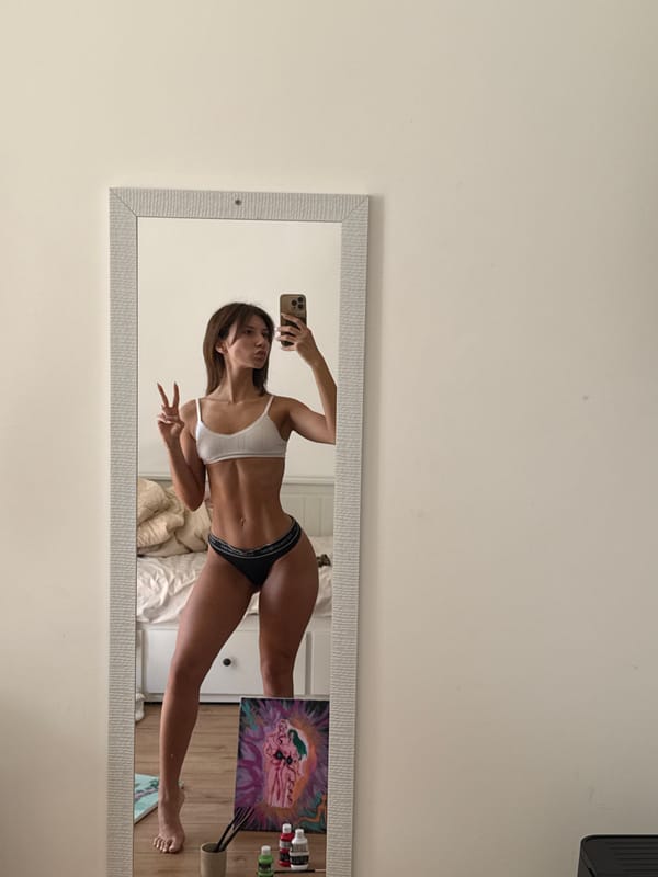 Woman takes mirror selfie with peace sign in Sofia