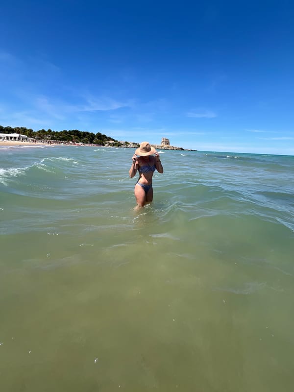 Beach day in Peschici with Adriatic waves and windsurfing