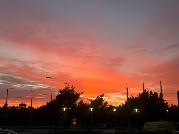 Vibrant sunset illuminates Tallinn skies in dramatic evening display