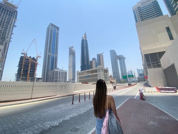 Woman poses on Dubai street amid downtown skyline